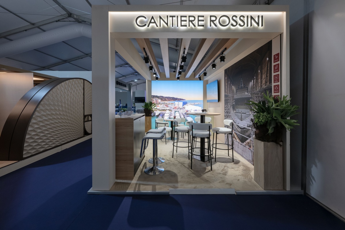 Interior of the Cantiere Rossini stand at Monaco Yacht Show 2026, featuring wooden ceiling elements, integrated lighting and a hospitality area